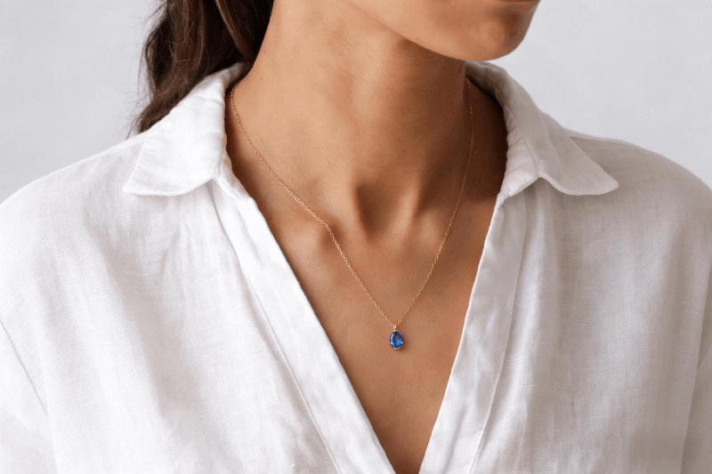A photorealistic AI-generated neck and collarbone model, showcasing a real necklace product laying naturally and organically against the skin, demonstrating ideal fit and draping.